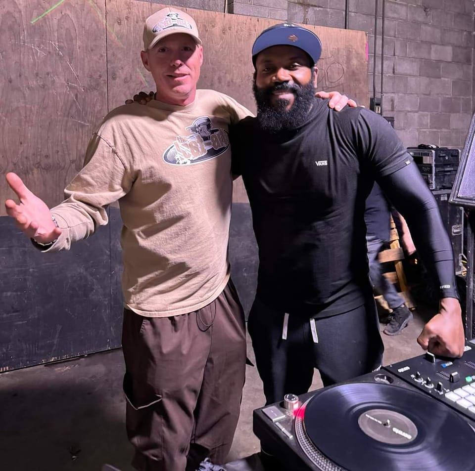 DJ Natural Nate® in The-Lost-Art™ shirt with a friend backstage at a Vans event